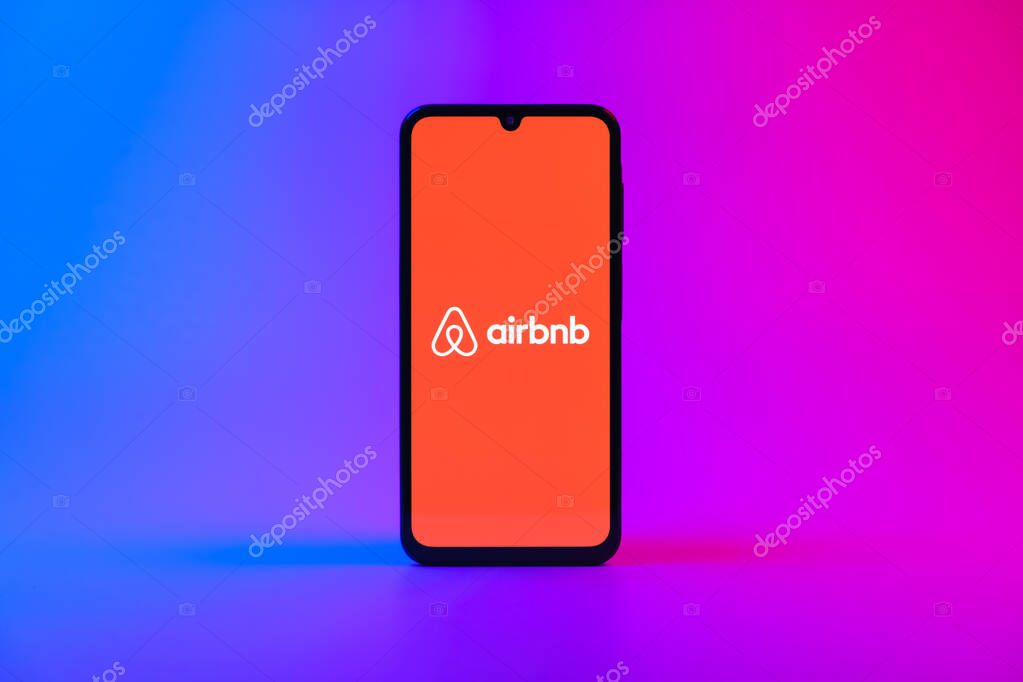 Prague, Czechia - 10 21 2024: Smartphone on surface showing Airbnb logo.