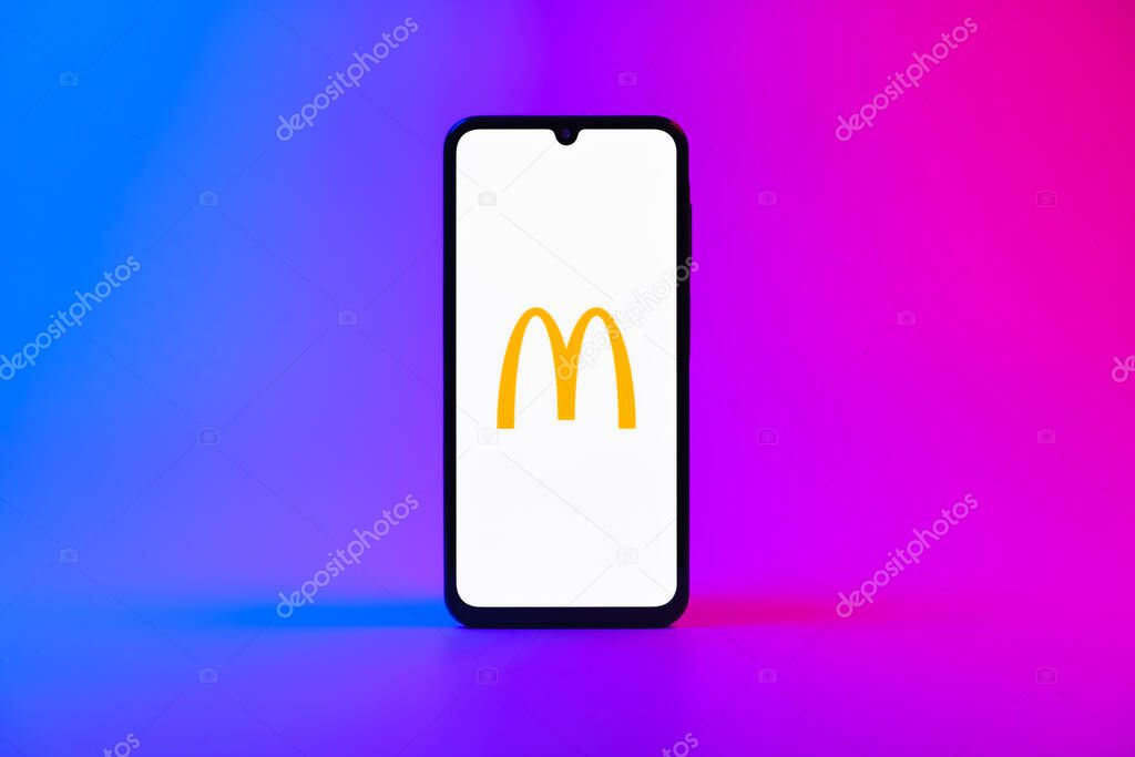 Prague, Czechia - 10 21 2024: Smartphone on surface showing McDonalds logo.