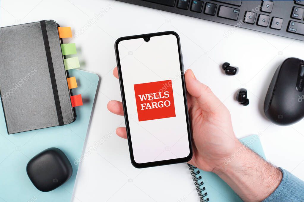 Prague, Czechia - 10 21 2024: Smartphone on surface showing Wells Fargo logo.