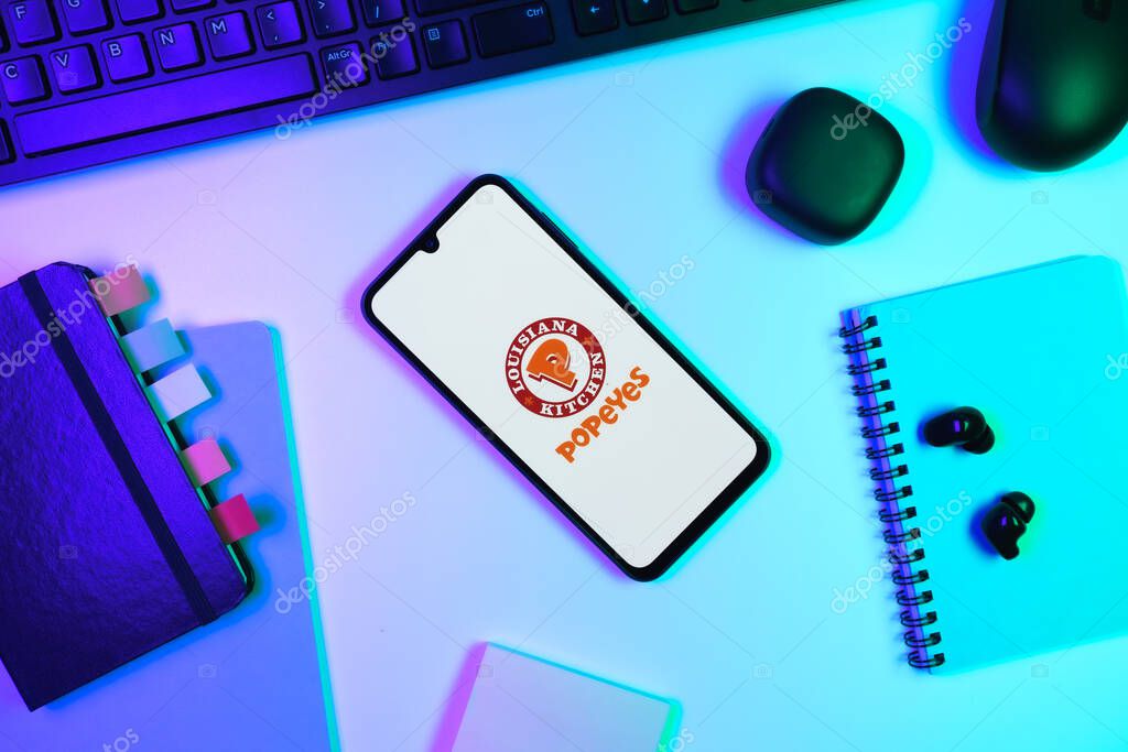 Prague, Czechia - 10 21 2024: Smartphone on surface showing Popeyes logo.
