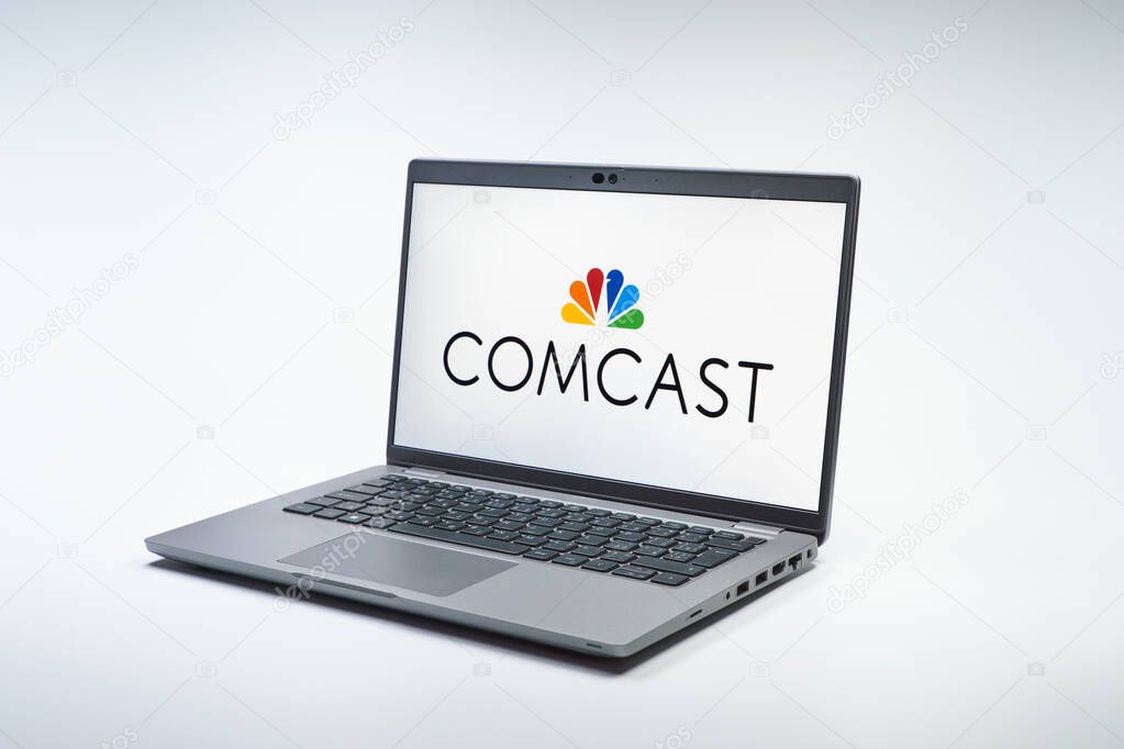 Prague, Czechia - 02 21 2025: Laptop on surface showing Comcast logo.