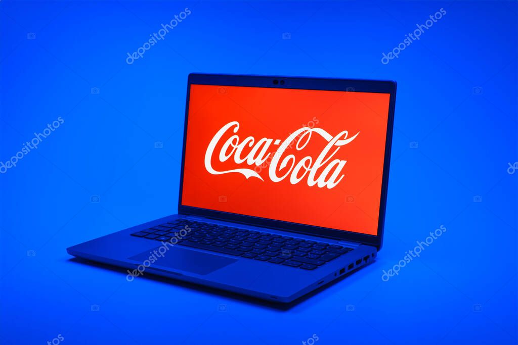 Prague, Czechia - 02 21 2025: Laptop on surface showing Coca-Cola logo.