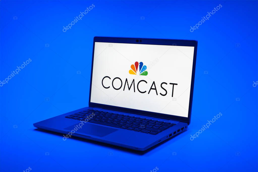 Prague, Czechia - 02 21 2025: Laptop on surface showing Comcast logo.