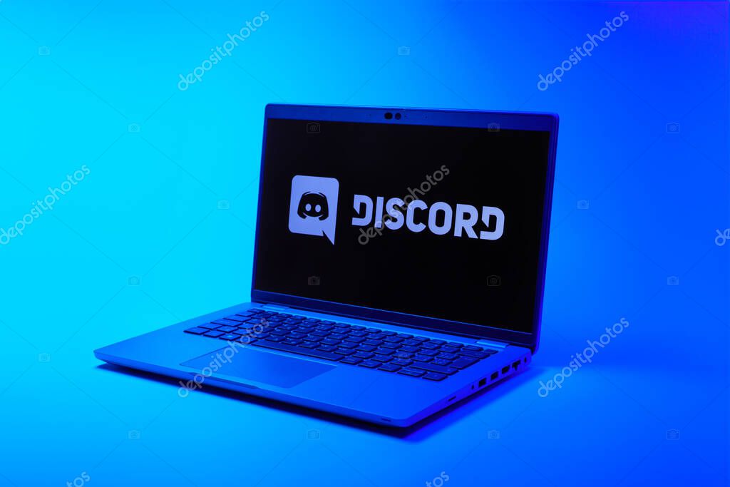 Prague, Czechia - 02 21 2025: Laptop on surface showing Discord logo.