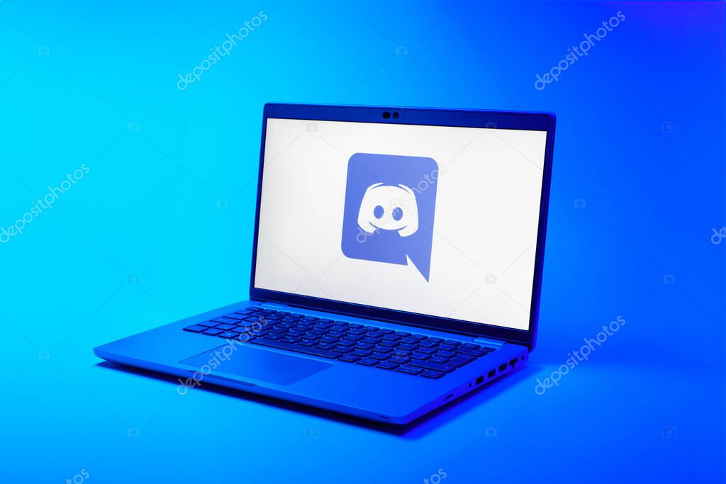 Prague, Czechia - 02 21 2025: Laptop on surface showing Discord logo.