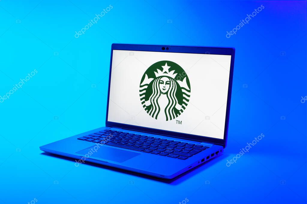Prague, Czechia - 02 21 2025: Laptop on surface showing Starbucks logo.
