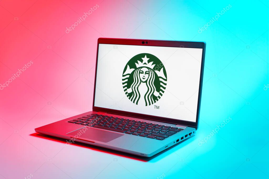 Prague, Czechia - 02 21 2025: Laptop on surface showing Starbucks logo.