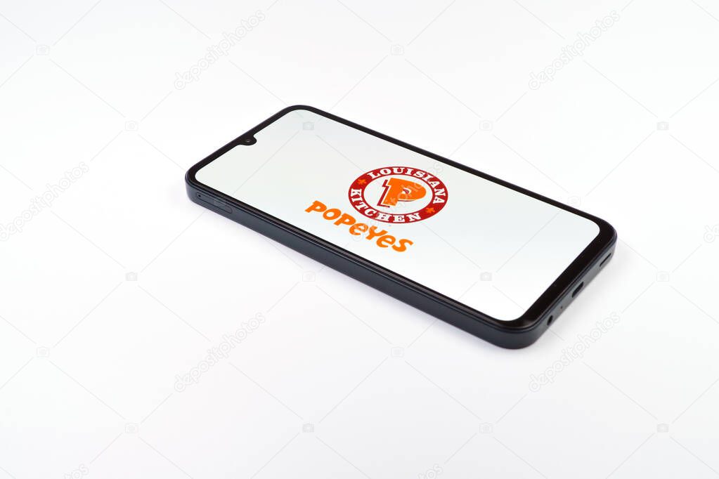 Prague, Czechia - 02 21 2025: Laptop on surface showing Popeyes logo.