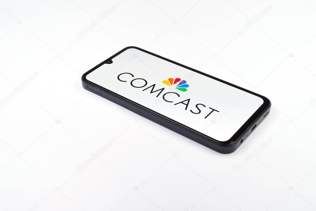 Prague, Czechia - 02 21 2025: Laptop on surface showing Comcast logo.
