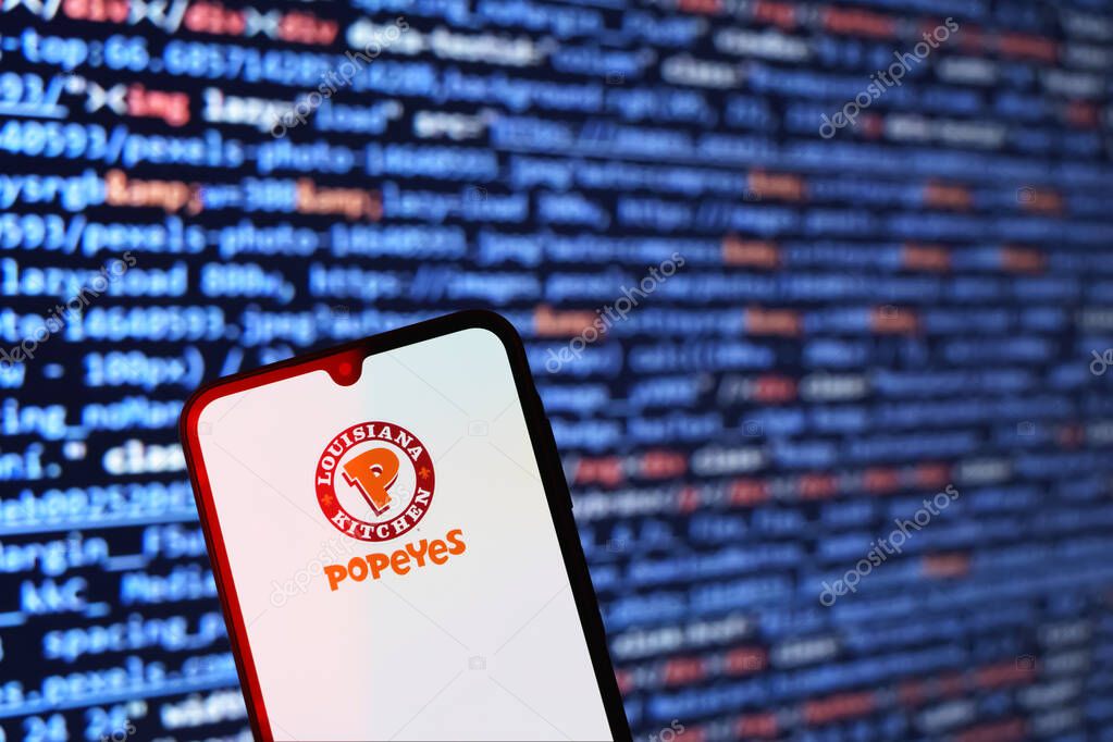 Prague, Czechia - 02 21 2025: Laptop on surface showing Popeyes logo.