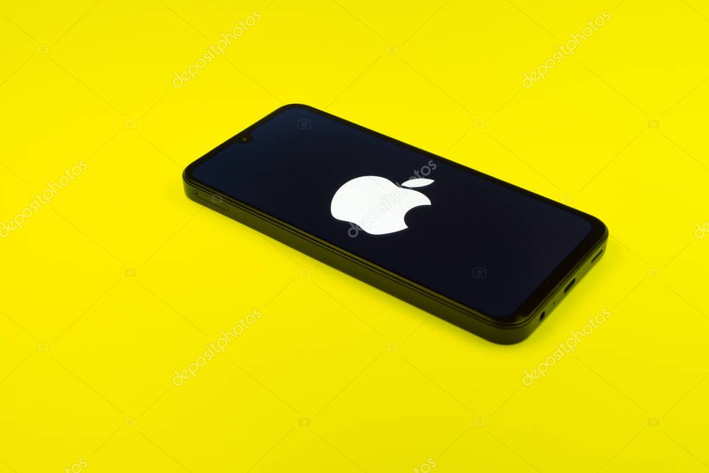 Prague, Czechia - 02 21 2025: Laptop on surface showing Apple logo.