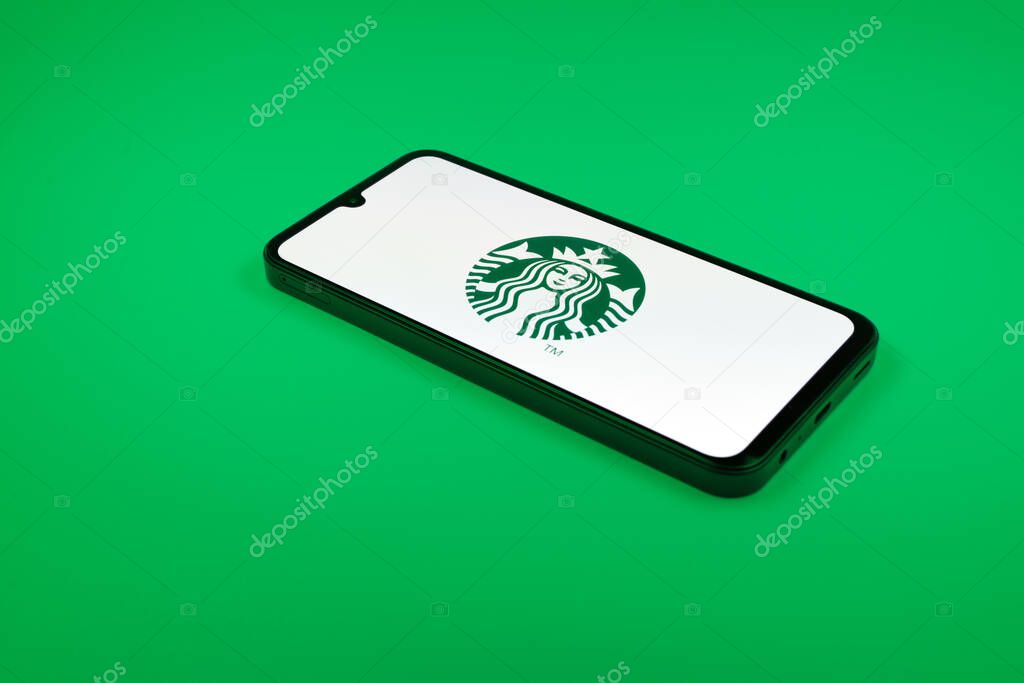 Prague, Czechia - 02 21 2025: Laptop on surface showing Starbucks logo.