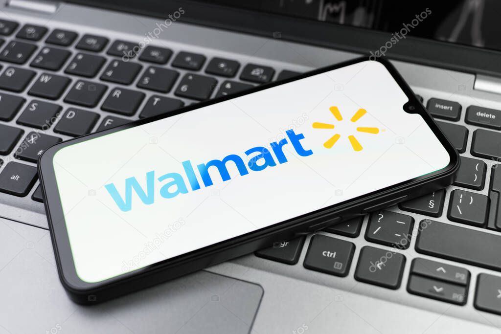 Prague, Czechia - 02 21 2025: Laptop on surface showing Walmart logo.