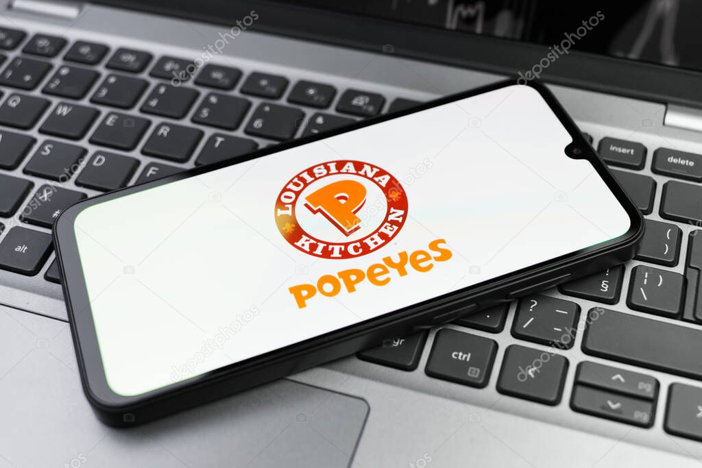Prague, Czechia - 02 21 2025: Laptop on surface showing Popeyes logo.