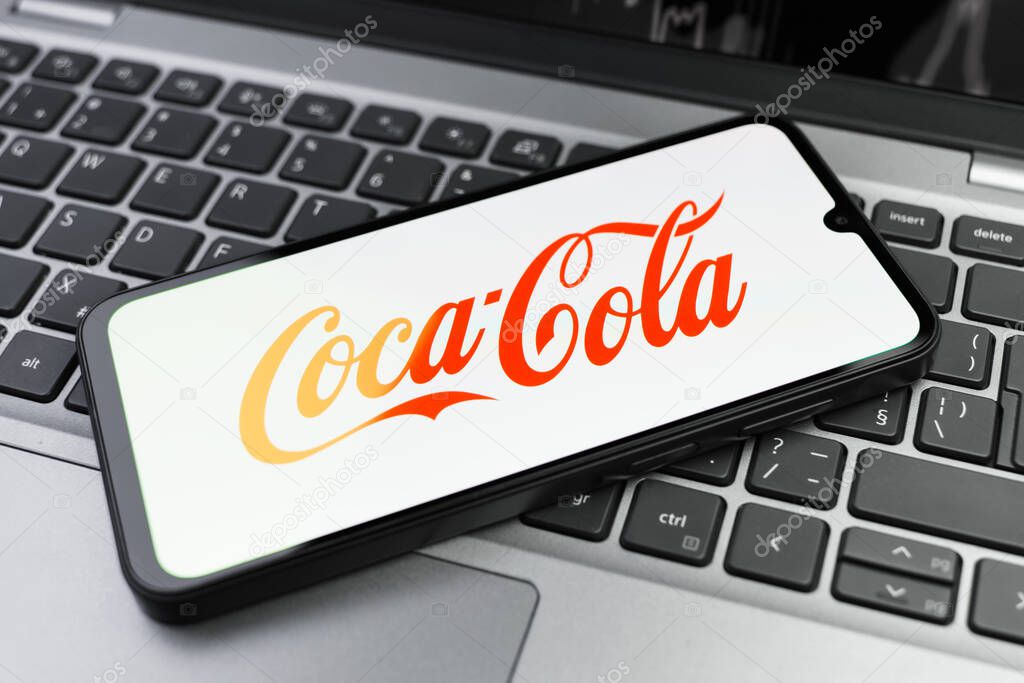 Prague, Czechia - 02 21 2025: Laptop on surface showing Coca-Cola logo.