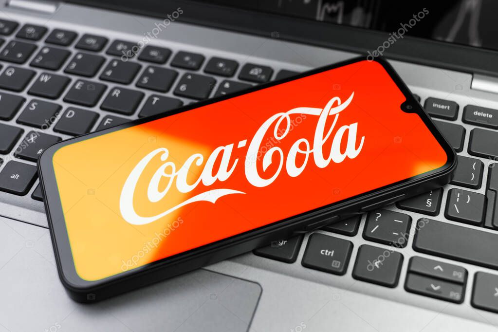 Prague, Czechia - 02 21 2025: Laptop on surface showing Coca-Cola logo.