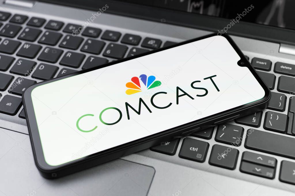 Prague, Czechia - 02 21 2025: Laptop on surface showing Comcast logo.