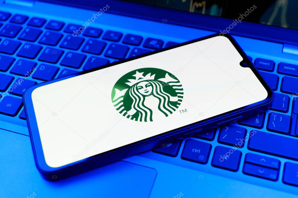 Prague, Czechia - 02 21 2025: Laptop on surface showing Starbucks logo.