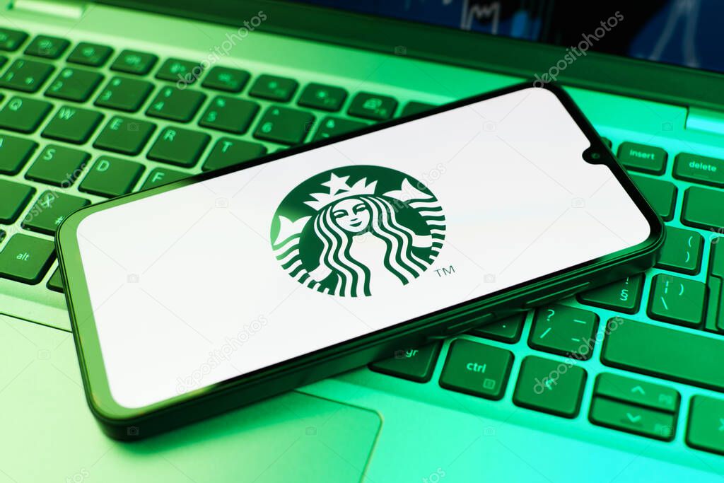 Prague, Czechia - 02 21 2025: Laptop on surface showing Starbucks logo.