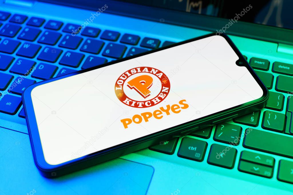 Prague, Czechia - 02 21 2025: Laptop on surface showing Popeyes logo.