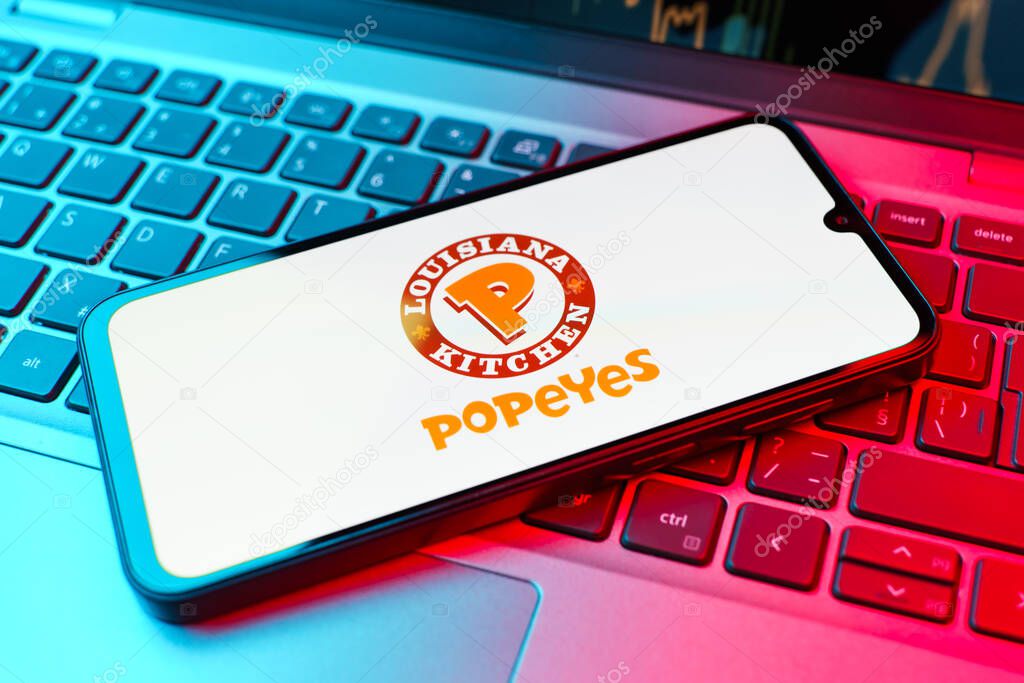 Prague, Czechia - 02 21 2025: Laptop on surface showing Popeyes logo.