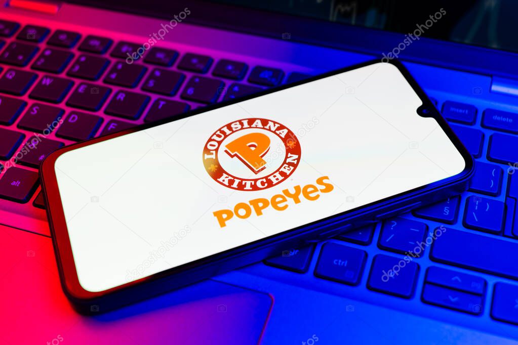 Prague, Czechia - 02 21 2025: Laptop on surface showing Popeyes logo.