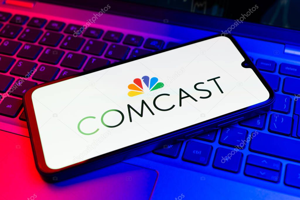 Prague, Czechia - 02 21 2025: Laptop on surface showing Comcast logo.