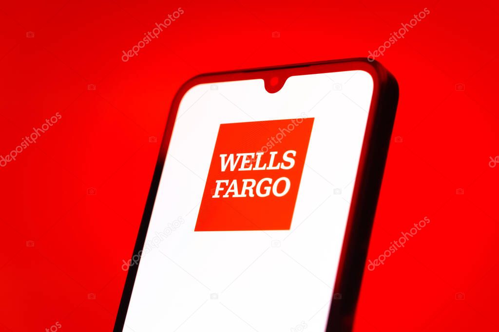 Prague, Czechia - 10 21 2024: Smartphone on surface showing Wells Fargo logo.