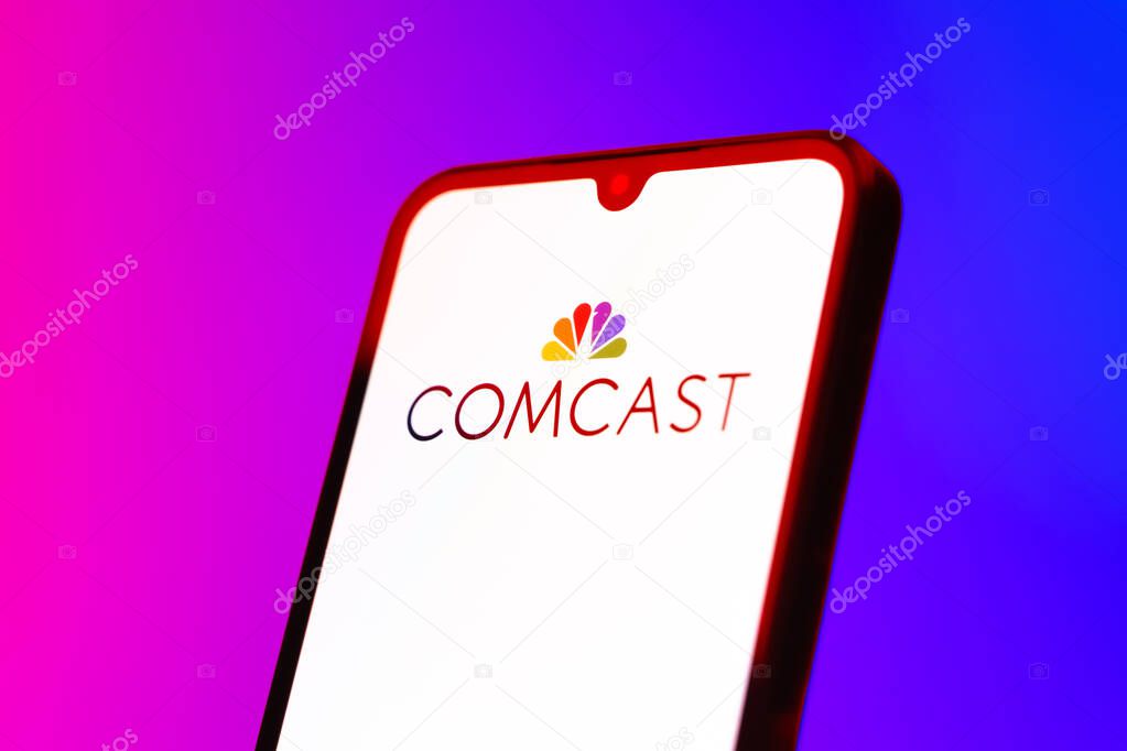 Prague, Czechia - 10 21 2024: Smartphone on surface showing Comcast logo.
