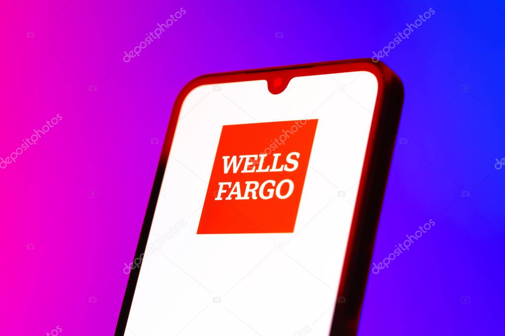 Prague, Czechia - 10 21 2024: Smartphone on surface showing Wells Fargo logo.