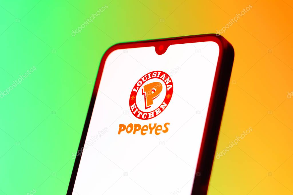 Prague, Czechia - 10 21 2024: Smartphone on surface showing Popeyes logo.