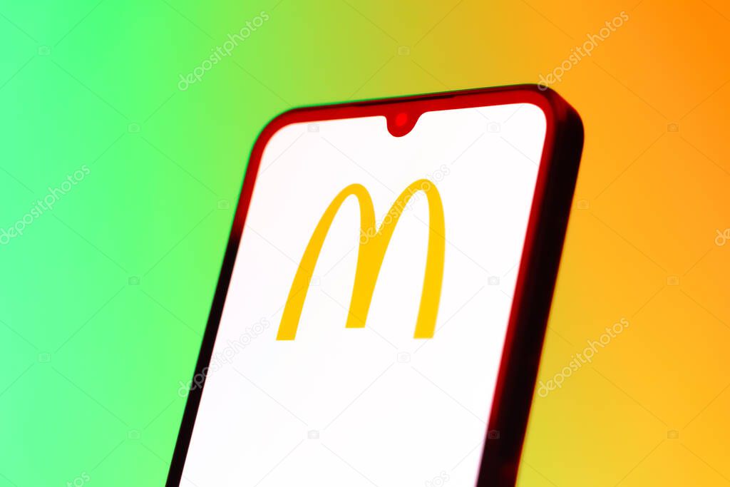 Prague, Czechia - 10 21 2024: Smartphone on surface showing McDonalds logo.