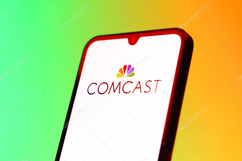 Prague, Czechia - 10 21 2024: Smartphone on surface showing Comcast logo.