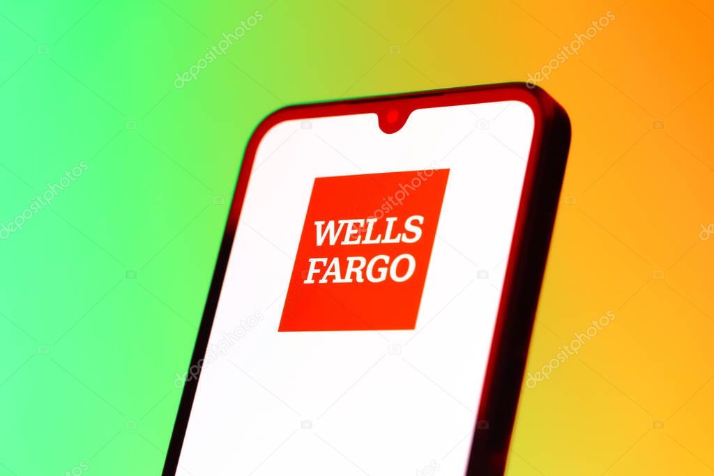 Prague, Czechia - 10 21 2024: Smartphone on surface showing Wells Fargo logo.