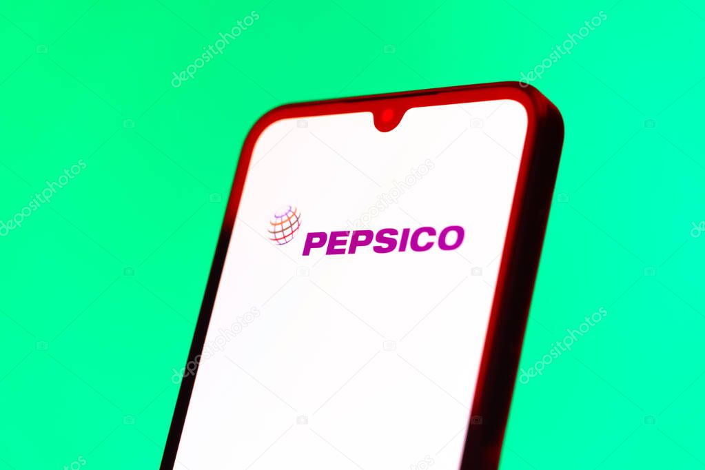 Prague, Czechia - 10 21 2024: Smartphone on surface showing Pepsico logo.