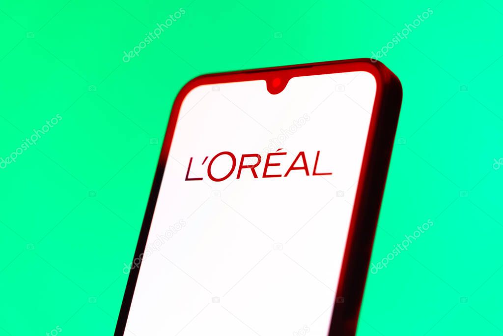 Prague, Czechia - 10 21 2024: Smartphone on surface showing L'Oreal logo.