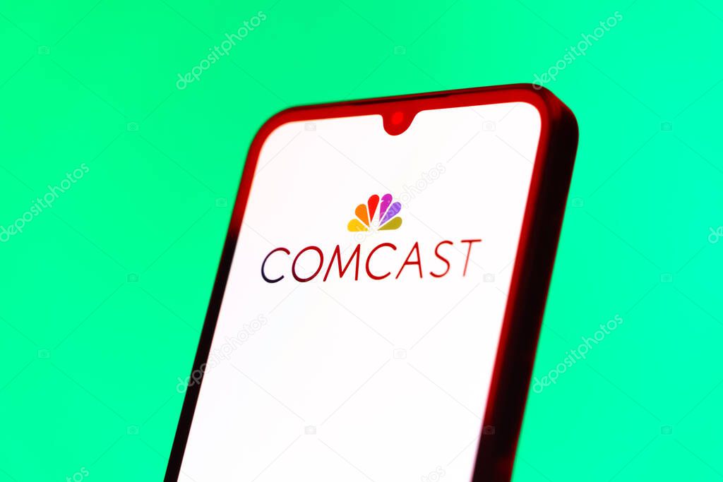 Prague, Czechia - 10 21 2024: Smartphone on surface showing Comcast logo.