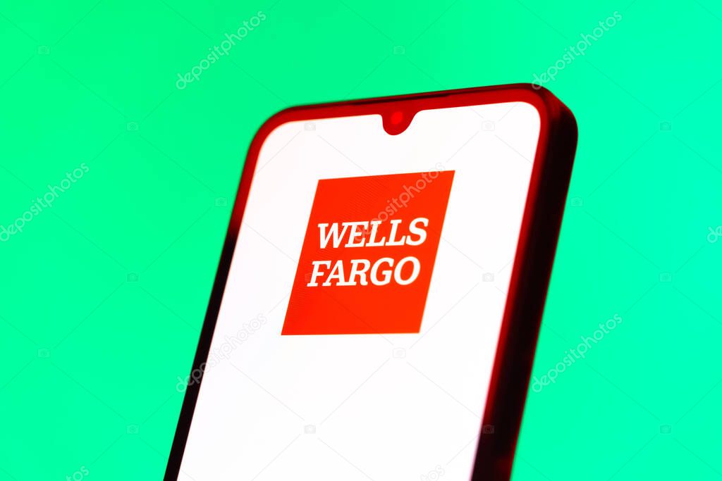 Prague, Czechia - 10 21 2024: Smartphone on surface showing Wells Fargo logo.
