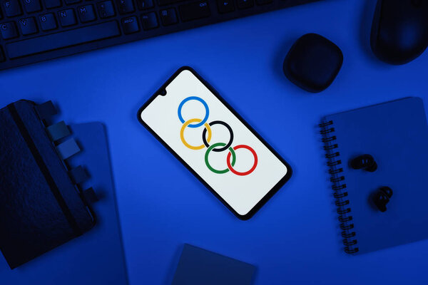 Prague, Czechia - 10 21 2024: Smartphone on surface showing Olympics logo.