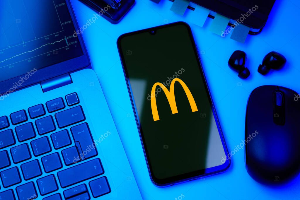 Prague, Czechia - 10 21 2024: Smartphone on surface showing McDonalds logo.