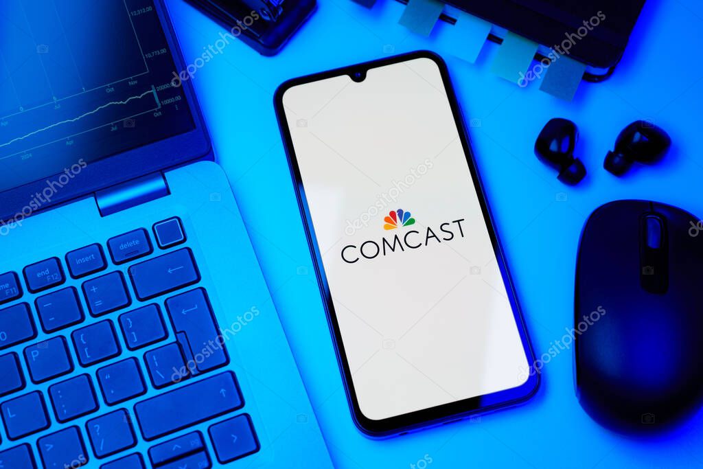 Prague, Czechia - 10 21 2024: Smartphone on surface showing Comcast logo.