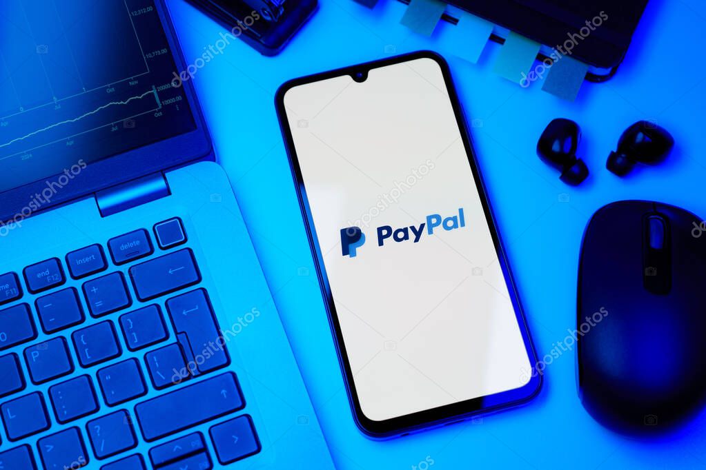 Prague, Czechia - 10 21 2024: Smartphone on surface showing PayPal logo.