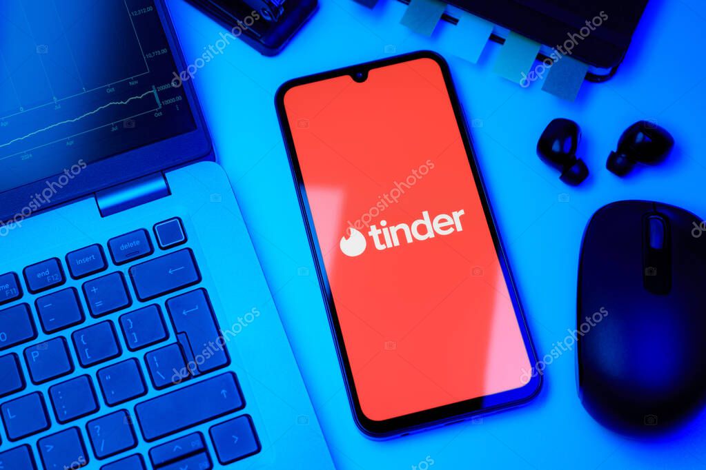 Prague, Czechia - 10 21 2024: Smartphone on surface showing Tinder logo.