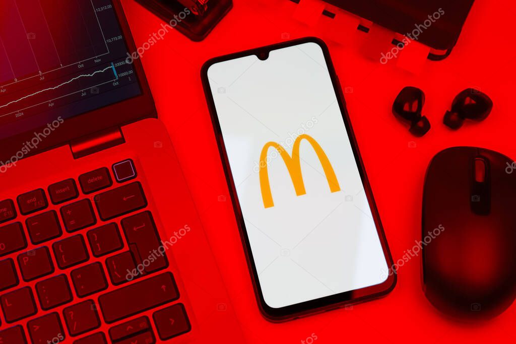 Prague, Czechia - 10 21 2024: Smartphone on surface showing McDonalds logo.
