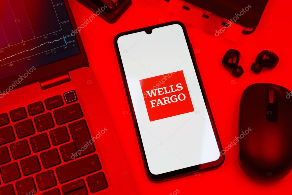 Prague, Czechia - 10 21 2024: Smartphone on surface showing Wells Fargo logo.
