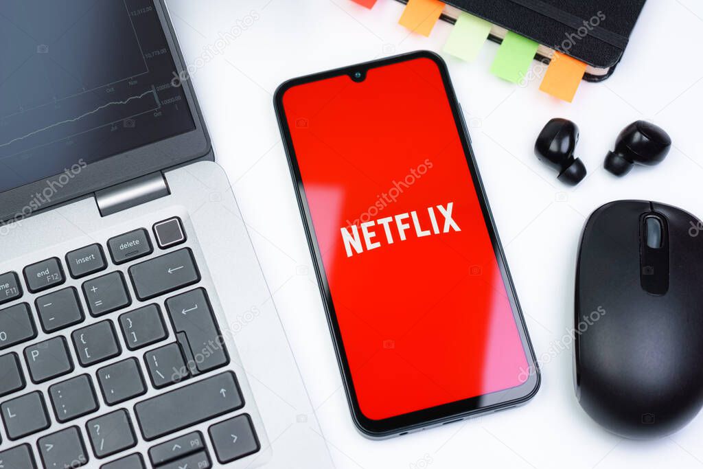 Prague, Czechia - 10 21 2024: Smartphone on surface showing Netflix logo.