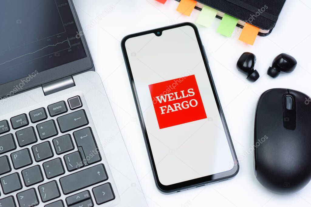 Prague, Czechia - 10 21 2024: Smartphone on surface showing Wells Fargo logo.
