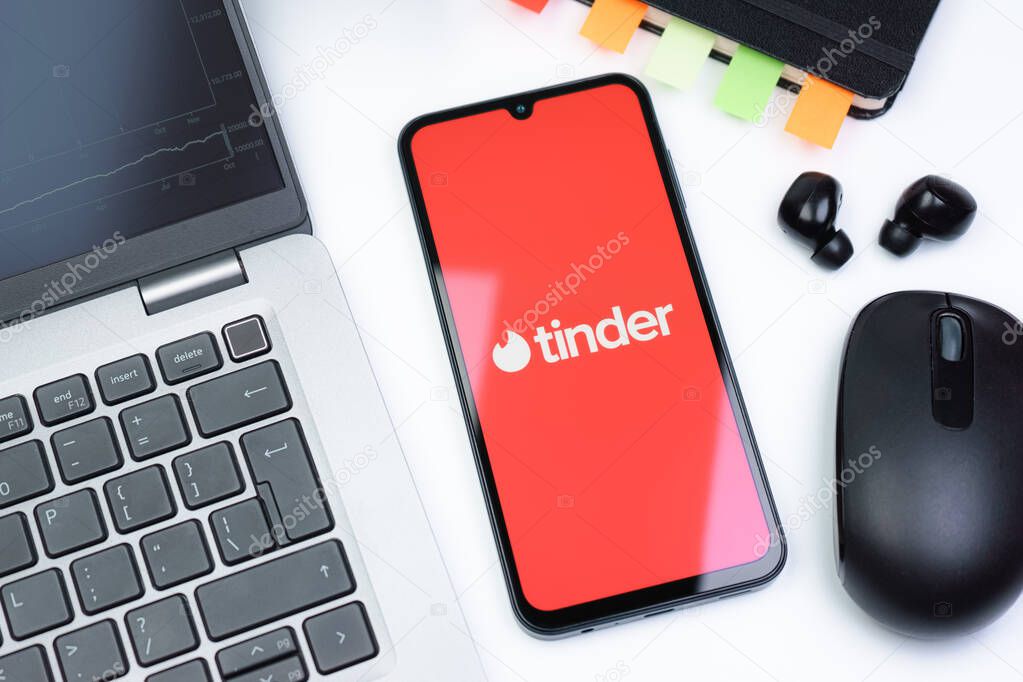 Prague, Czechia - 10 21 2024: Smartphone on surface showing Tinder logo.