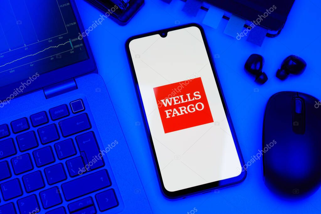 Prague, Czechia - 10 21 2024: Smartphone on surface showing Wells Fargo logo.