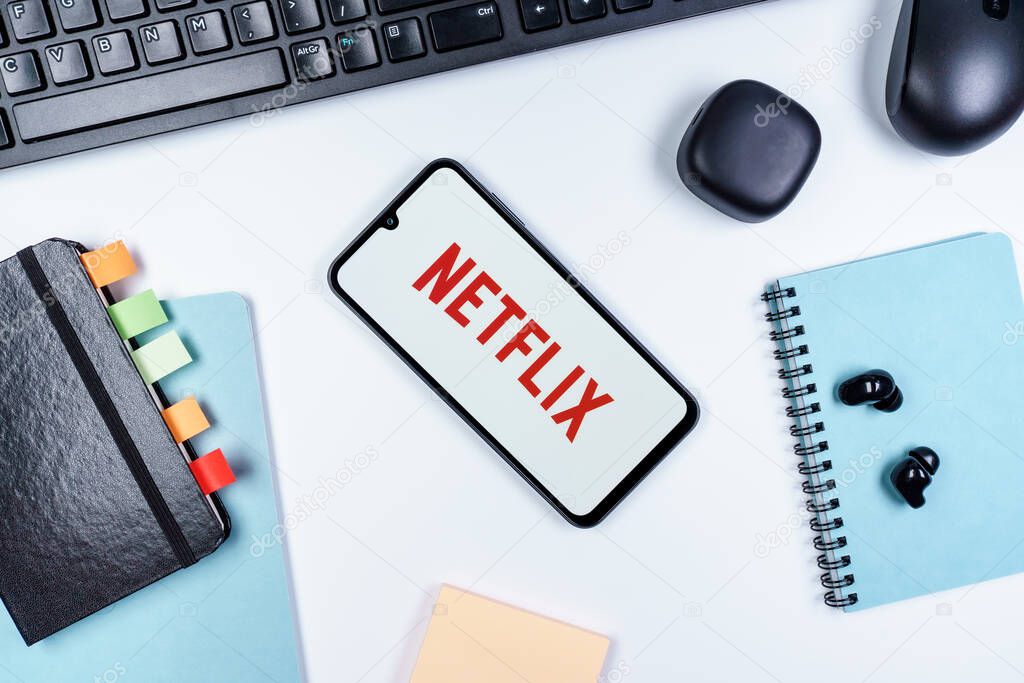 Prague, Czechia - 10 21 2024: Smartphone on surface showing Netflix logo.
